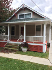 This Chagrin Falls home exterior was painted a neutral earth tone with contrasting coral and white trim