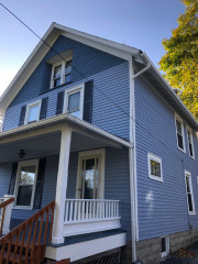 The homeowner of this Chardon Century home chose complimentary shades of blue to highlight the different features on their house, and chose a crisp white for the trim