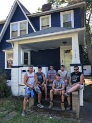 Northcoast College Painters team members posing in front of a finished painting project in Cleveland Heights